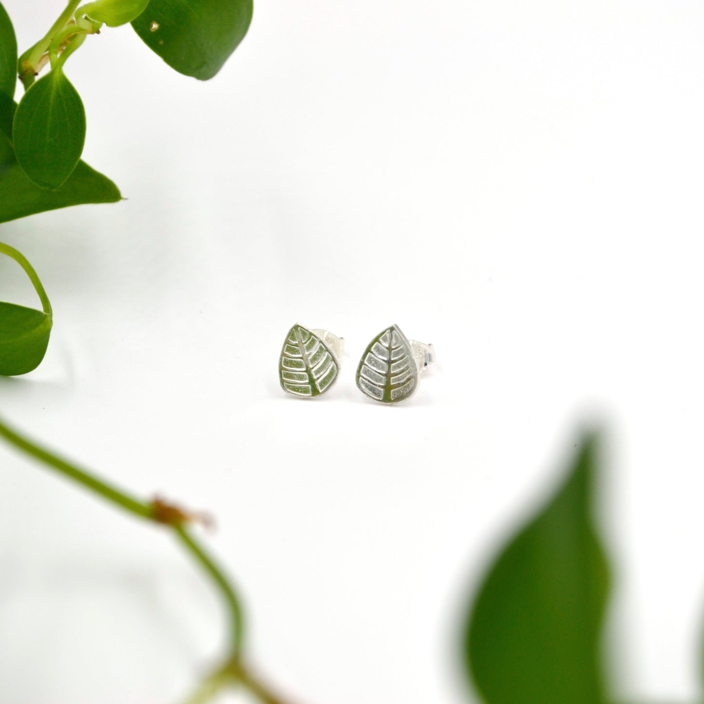 post earrings silver leaf shape white background with leaves